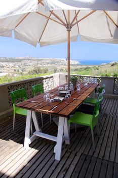 A table set for dinner outside on a terrace with amazing views