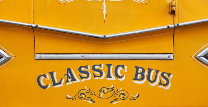 close up of a classic yellow Maltese bus