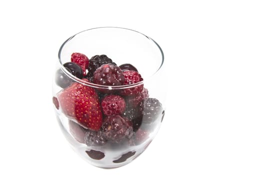 Raspberry, strawberry and blueberry served in a wine glass