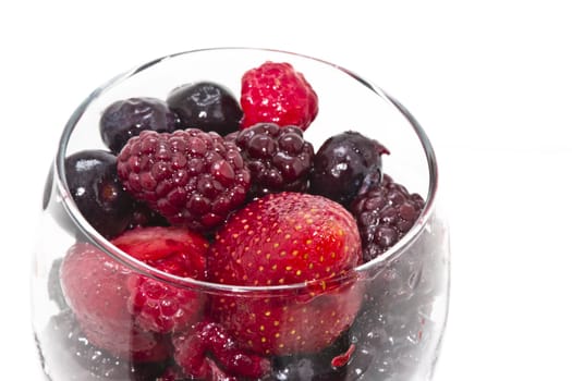 Raspberry, strawberry and blueberry served in a wine glass