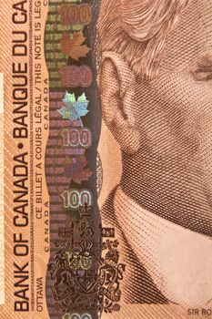 Closeup of the portrait of Sir Robert Borden on a 100 dollar Canadian bill