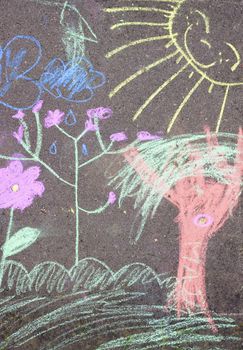 A detail of a child's colourful chalk picture on the pavement