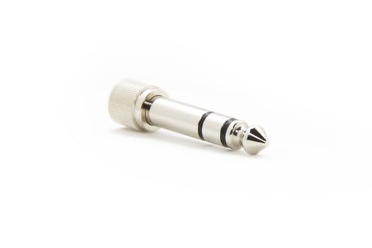 An silver colored audio connector isolated on a white background