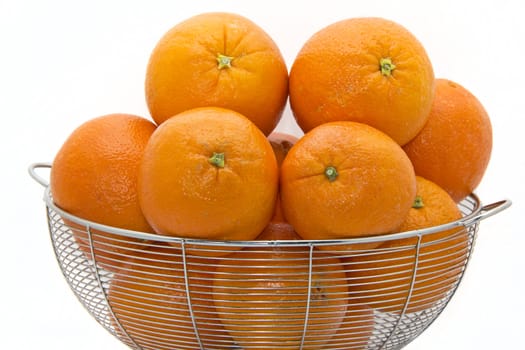 Delicious ripe Florida oranges stacked up on a white plate