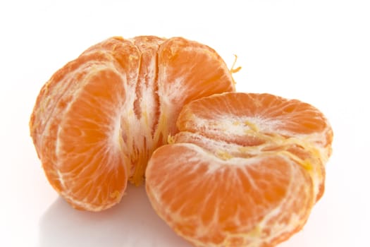 Pealed mandarine orange whole piece on a white background