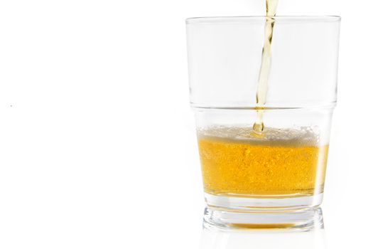 Pouring beer into a glass; isolated on a white background with clipping path