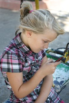 A young girl texting on her mobile phone