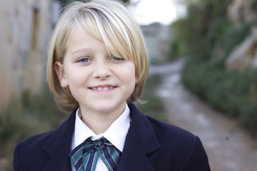A school girl dressed in a Brittish school uniform blazer and bow tie