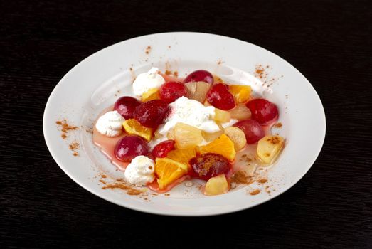 fruit salad of pineapple, grape, orange and strawberry with whipped cream