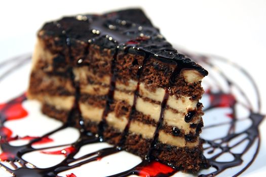 close up of chocolate cake with red drops