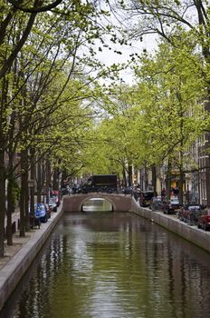 Canal in Amsterdam. Spring cityscape. Bicycles are on the waterfront.