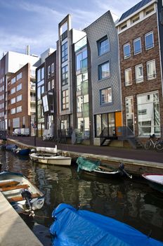 Modern residential houses on the canal in Amsterdam. Spring cityscape.