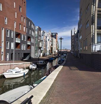 Modern residential houses on the canal in Amsterdam. Spring cityscape.