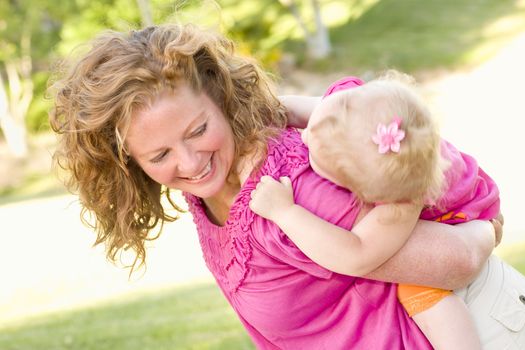 Mother and Daughter Piggyback Ride in the Park.
