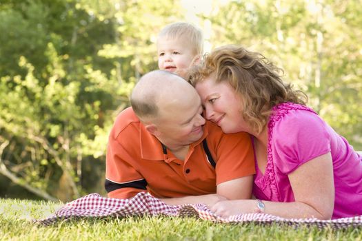 Affectionate Couple with Adorable Son in the Park.