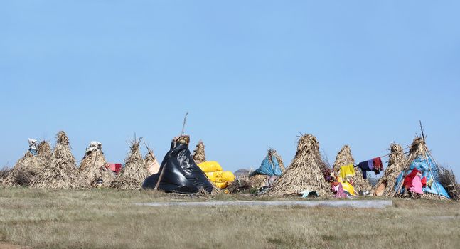 Nomad huts settlement in the Indian grasslands.
