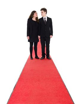 Couple standing on a red carpet isolated on white background