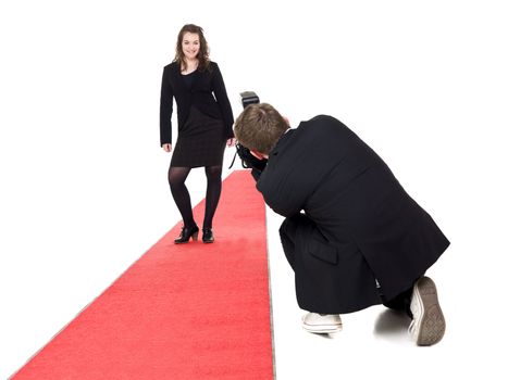 Photographer taking pictures on a woman posing on a red carpet