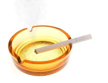 Smoking white cigarette in an ashtray on the white