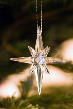 Star hanging as decoration in christmastree - shallow dept of field