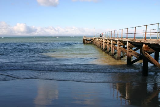 Old rusted ocean Pier at almost low tide 