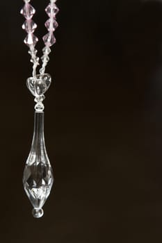 Crystal decoration hanging against a black background 