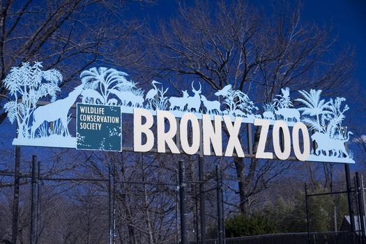 New York, NY - March 29, 2011: Bronx Zoo Sign at parking entrance against blue sky