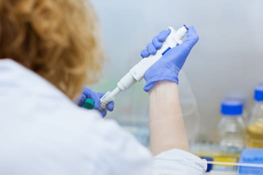 portrait of a female researcher doing research in a lab (shallow DOF; color toned image)