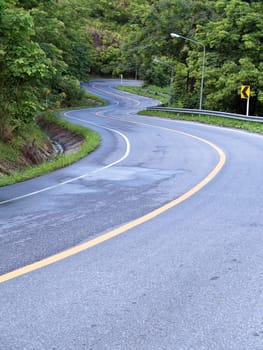 Road curves pass through the mountain and forest