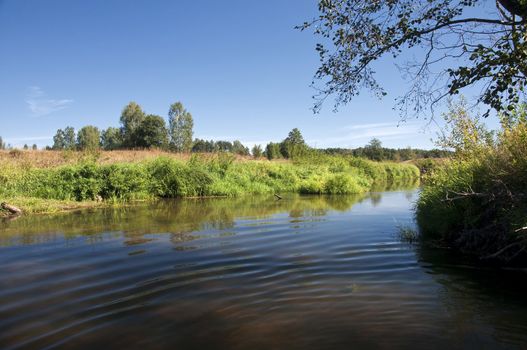 Summer landscape with river and cloudy sky