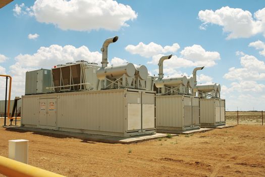 Gas compressor packages, heat sinks on top of containers.