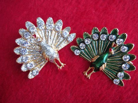 Couple of white and green decorations peacock shape on red background