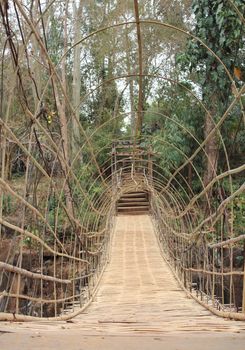 Suspension bamboo bridge at water fall in Paksong City, Laos