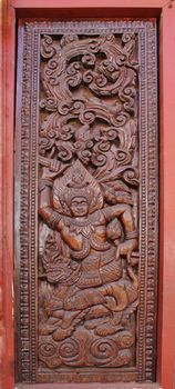 Decorated wooden beside door in Buddhist temple, Laos