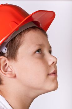 Portrait of a boy in a red protective helmet