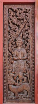 Decorated wooden beside door in Buddhist temple, Laos