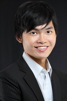 Young asian man in black suit