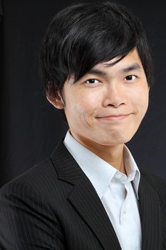 Young asian man in black suit