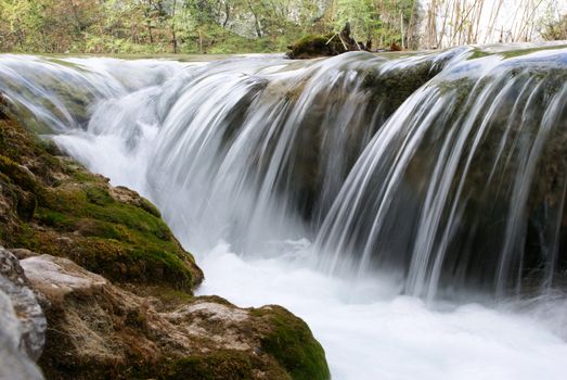 A beautiful waterfall and a part of rock photographed up close.