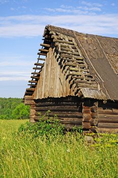 Old abandoned broken wooden barn in russian village