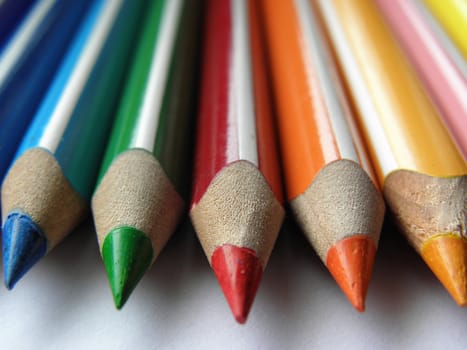 Crayons photographed on a sheet of paper. Close-up.