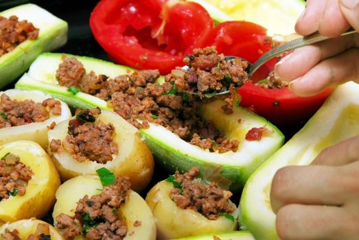 preparing fresh stuffed vegetables with minced meat