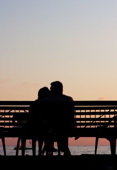 Silhouette of a young couple on a beach at sunset