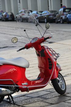 Red scooter, Turin, Italy, detals, mirror, speedometr. Scooter is in focus, background is out of focus.