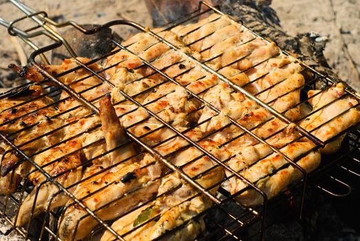 Chicken barbecue roasting on an open fire