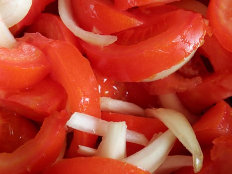 Prepared salad of tomato and onion. Photographed up close.