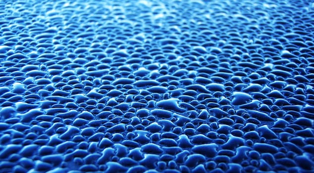 Water droplets photographed up close. Were photographed in their natural environment, under the open sky which is why they assumed a bright blue color.