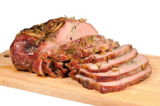 Roast pork on a wooden board. Isolated on white.