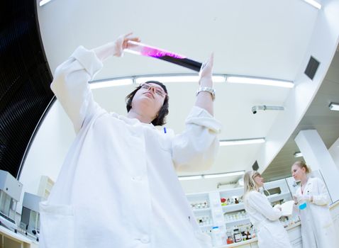 portrait of a female researcher carrying out research in a chemistry lab (color toned image; shallow DOF)