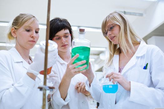 portrait of a female researcher carrying out research in a chemistry lab (color toned image; shallow DOF)